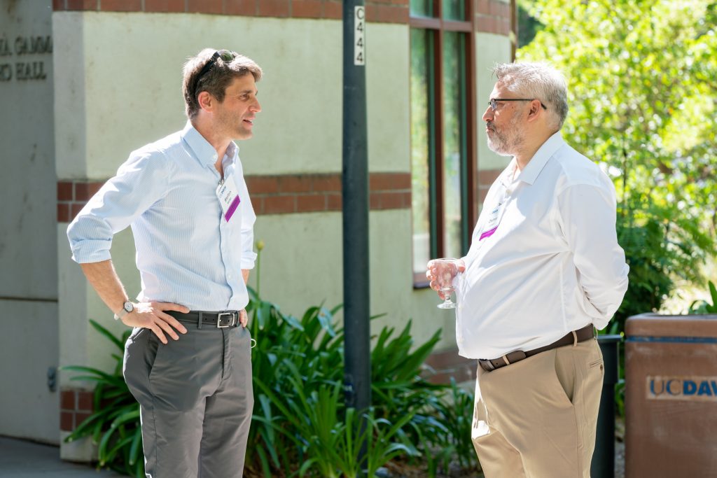 LibreTexts Executive Director and Founder, Delmar Larsen, converses with a colleague outside of a building on the UC Davis campus.